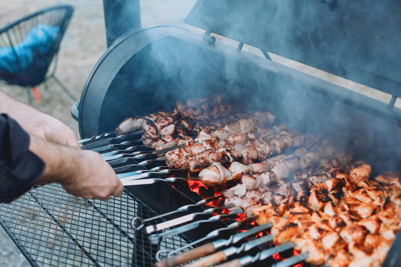 Skewers cooking over a charcoal grill