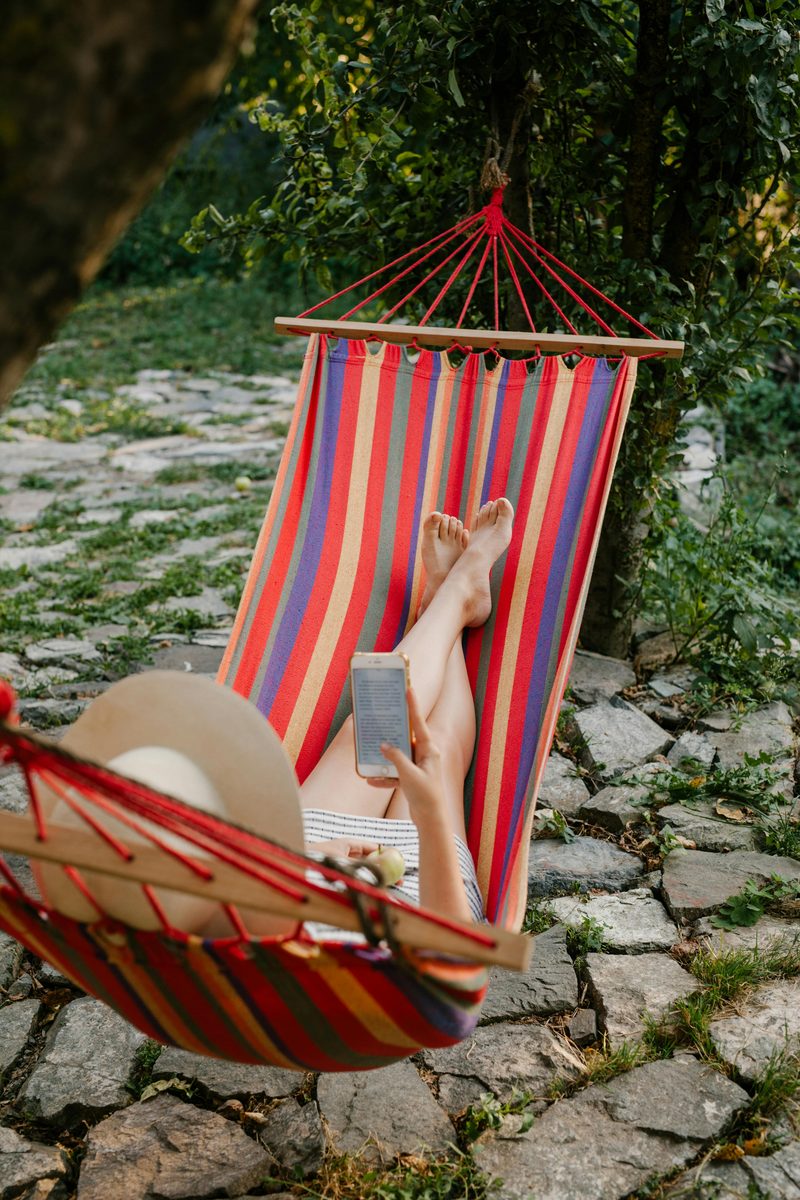 A hammock strung between trees in a garden