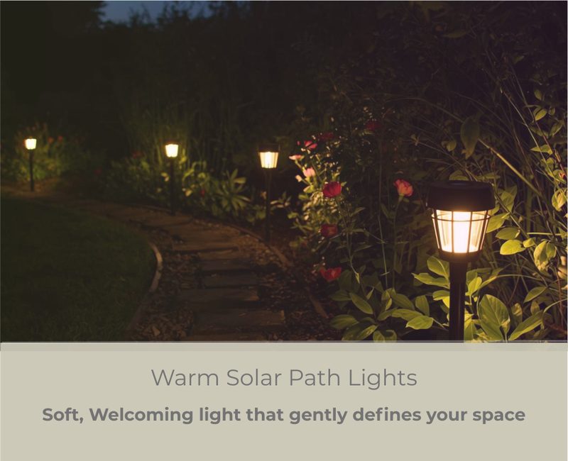 Warm solar path lights along a garden border at dusk