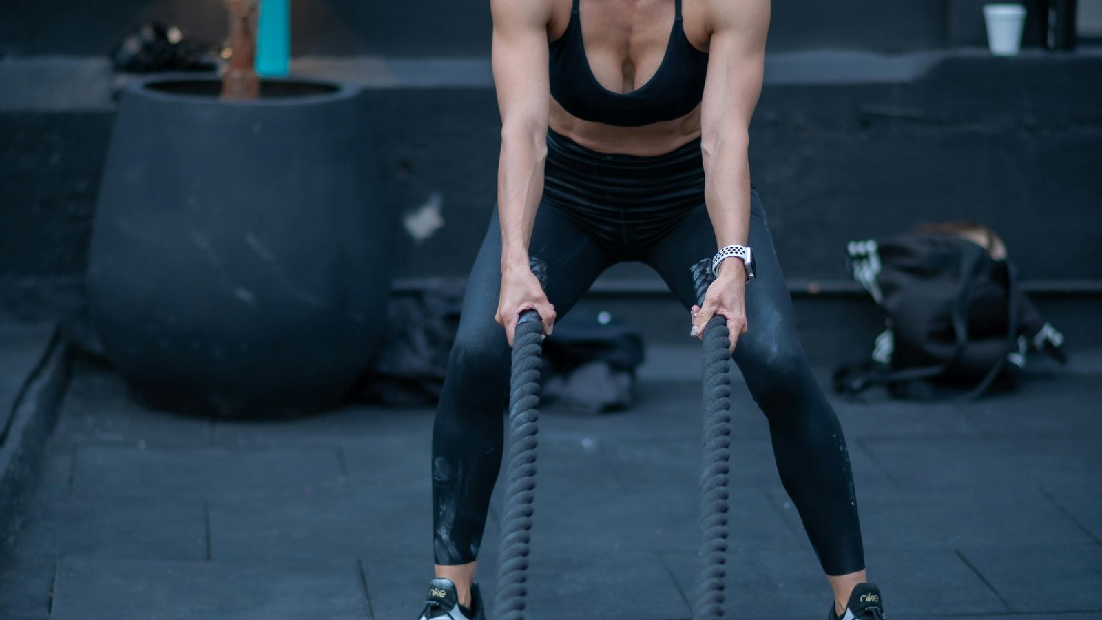 Working out with battle ropes in an outdoor training space