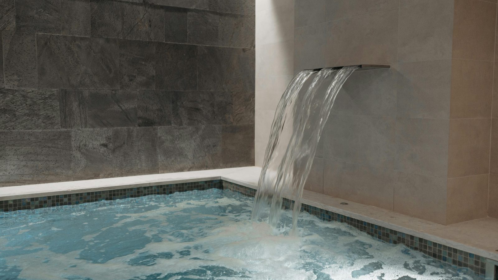 Water pouring into a small garden plunge pool